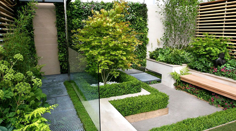 Outdoor space with a beautiful interior design with decorative elements, surrounded by lush greenery and plants